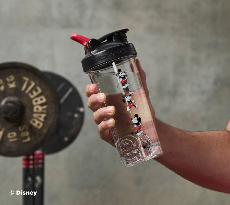 pro-series-d8 Mickey_Mouse_Protein_Shaker_Bottle_Being_Held_In_the_Gym.jpg